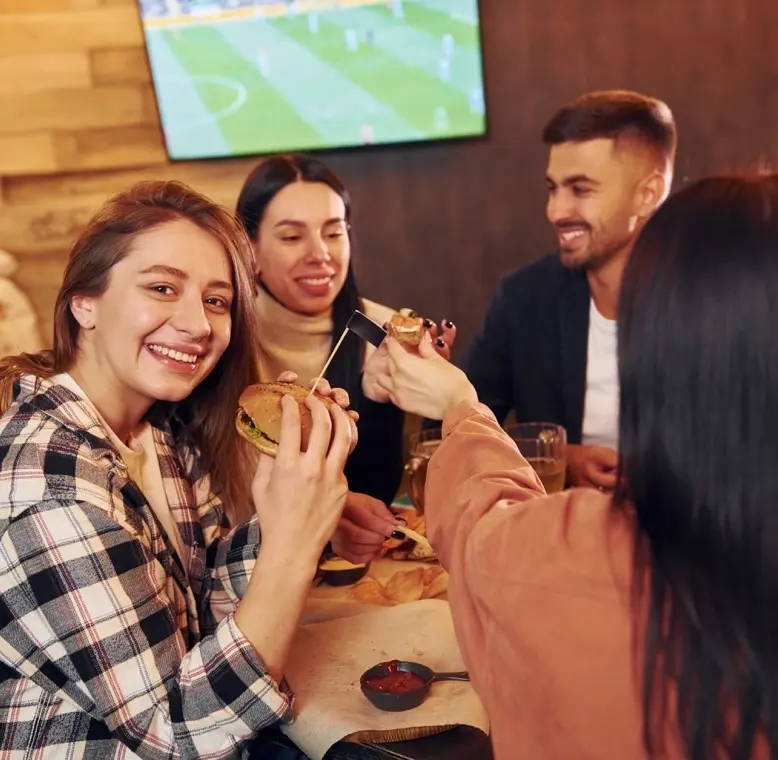 A table of friends enjoying a meal at Game Day Grill