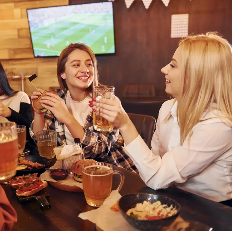  A group of two friends enjoying a meal at Game Day Grill.
